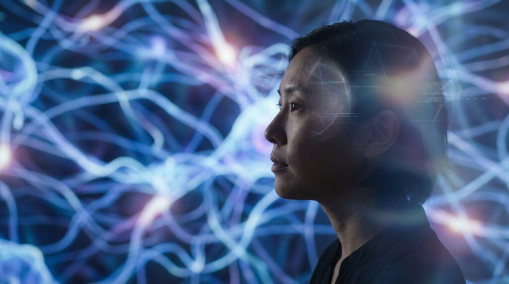 Profile of a person's head, right-facing, against a luminous abstract background of blue/purple neural pathways and geometric light patterns. Conveys thought and scientific inquiry.